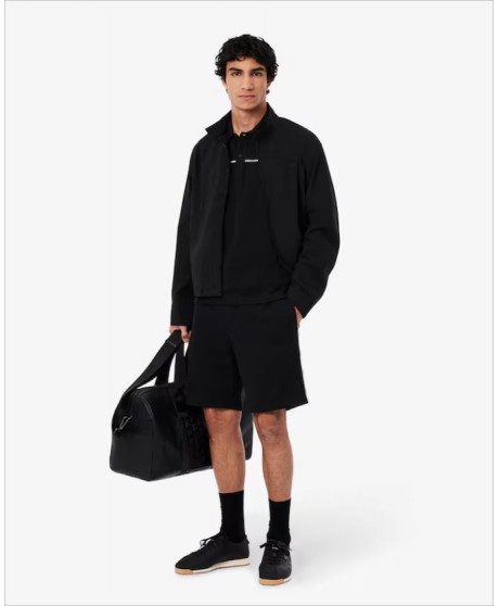 Polo negro L.12.12 regular ribete blanco logotipo LACOSTE